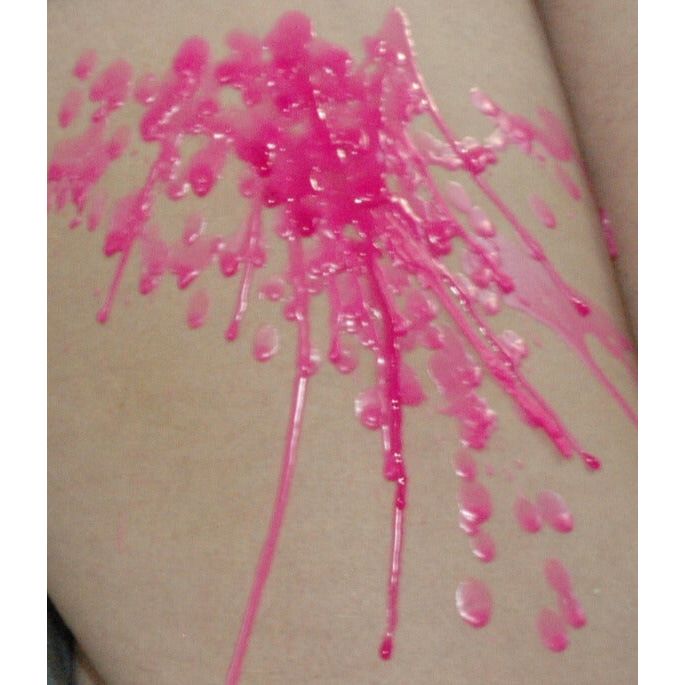 Pink dripping wax from candle with safe burn temperature for intimate sensory use.