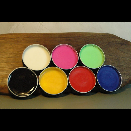 Colorful handmade wax paint tins used for kinky sensory exploration.